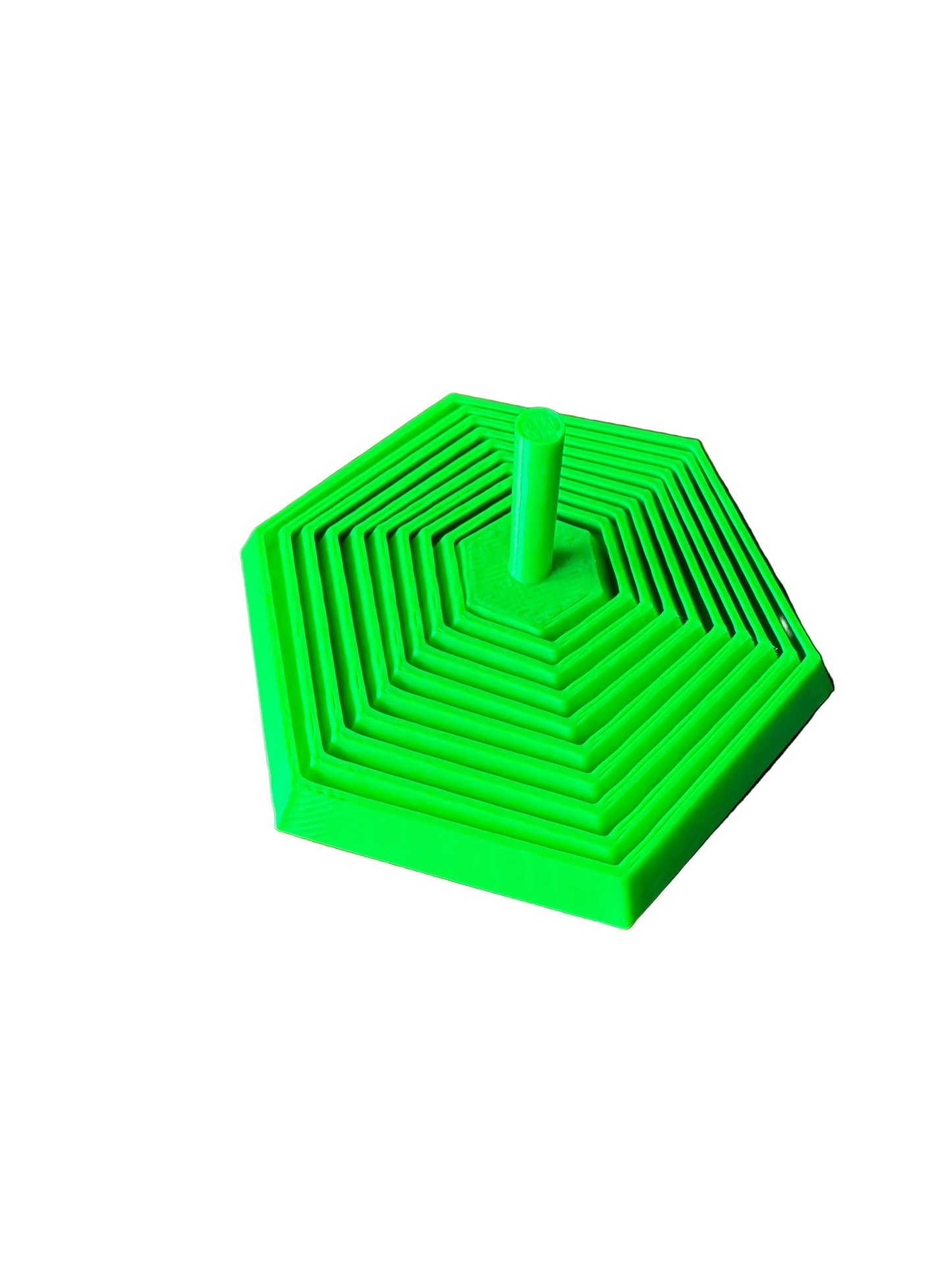 A bright green 3D-printed hexagonal nesting toy or puzzle with concentric square patterns and a central post, resting on a wooden tabletop.